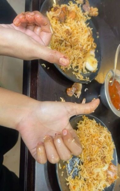 Diner giving thumbs up to Kewat's Biryani
